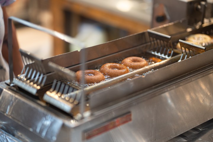 a group of donuts in a fryer