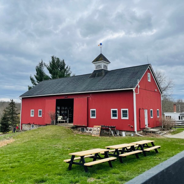 a red barn with tables outside
