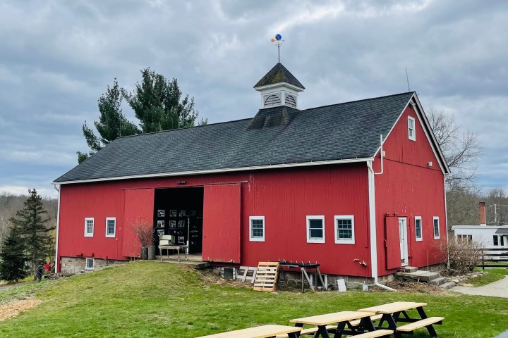 a red barn with tables outside