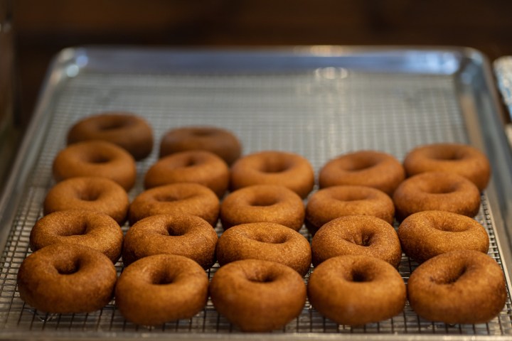 a group of donuts on a metal rack