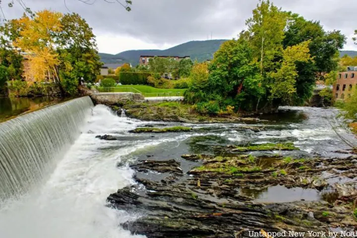 a large waterfall over a body of water