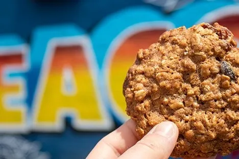 a hand holding a piece of cake
