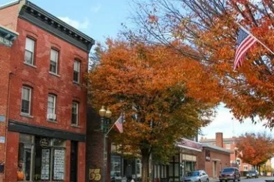 a large brick building with a store on the corner of a street