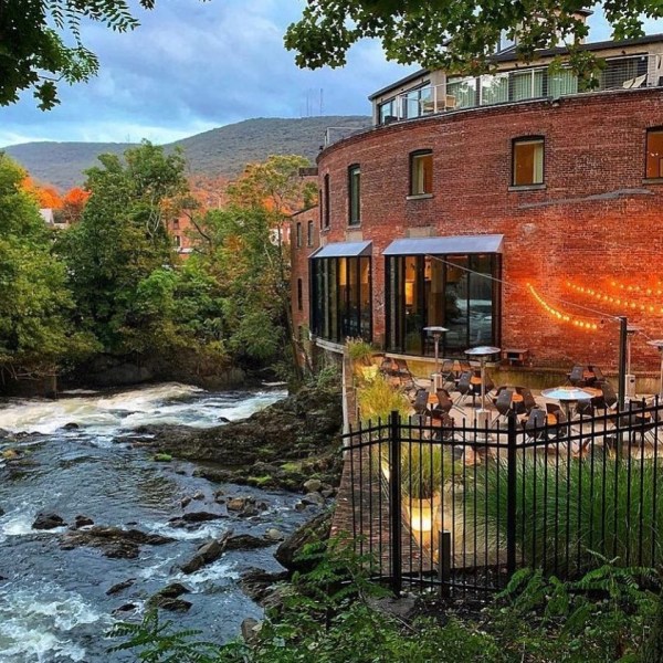 a large brick building with grass and trees