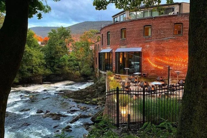 a large brick building with grass and trees