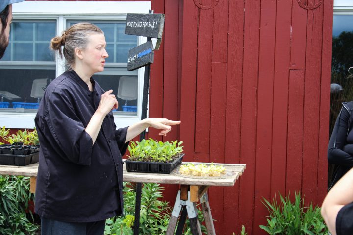 a woman standing in front of produce