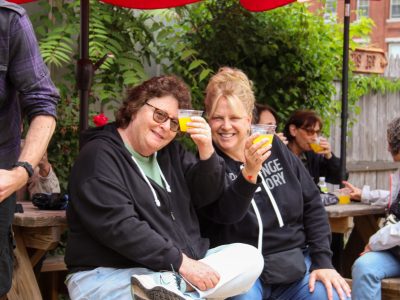 a group of people saying cheers as they drink