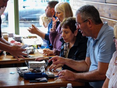 a group sitting at a table enjoying a food tour