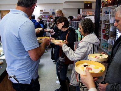 a group of people holding plates on a food tour