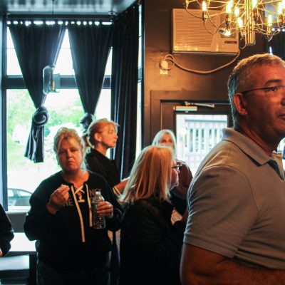 a group of people are drinking from a wine glass