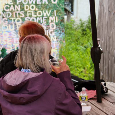 a woman sitting on a bench talking on a cell phone