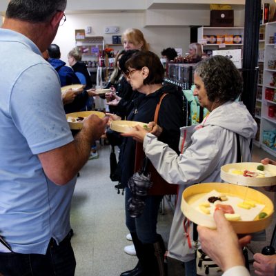 a group of people standing around a table