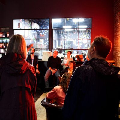 a group of people standing in a bar