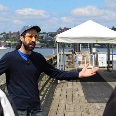 a man and a woman sitting at a dock