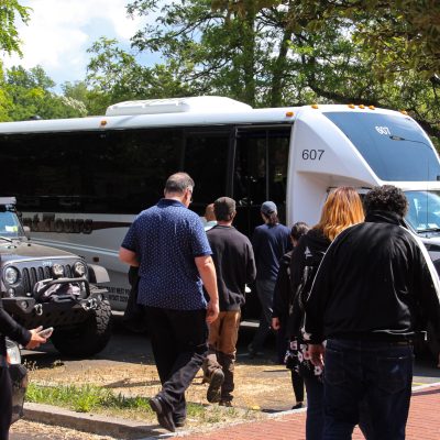a group of people standing in front of a car